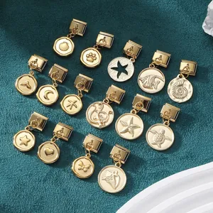 Macro view of gold Italian charm links featuring shells, stars, and nautical pendants