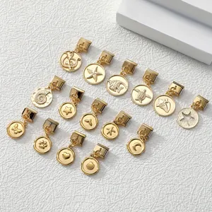 Close-up of 16 gold metal charms with ocean and celestial motifs for DIY jewelry