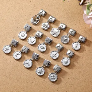 Macro shot of silver Italian charm pendants with diverse heart and star symbols