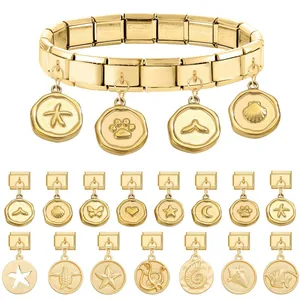 Gold stainless steel Italian charm bracelet with various marine-themed modular pendants