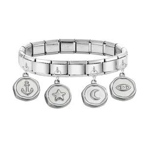 Detail of stainless steel Italian charm bracelet with anchor, star, moon and eye pendants