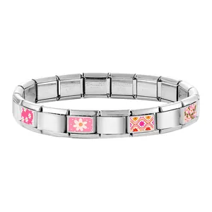 Detail of modular Italian charm bracelet showing floral patterns on stainless steel links