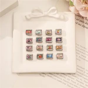 Close-up of sixteen floral modular charms for Italian link bracelets in vibrant colors
