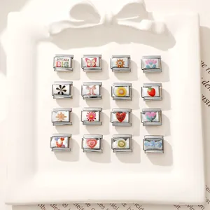 Macro view of 16-piece set of colorful enamel stainless steel Italian charms with icons