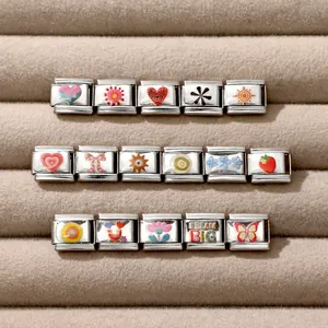 Detailed view of Italian charm links with colorful enamel heart and sun patterns