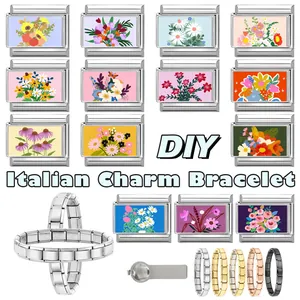 Macro view of modular Italian charms with floral patterns on multi-color stainless steel bands