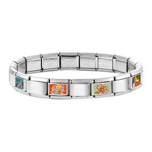 Detail of Italian modular bracelet links with colorful floral patterns on stainless steel