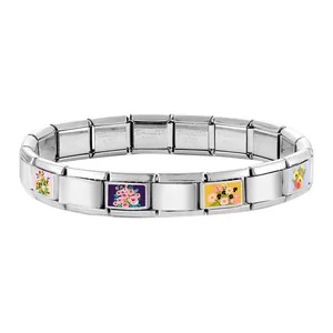 Detailed macro view of modular stainless steel links with colorful floral patterns
