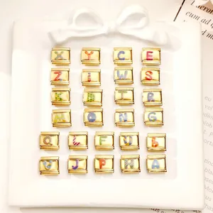 Macro shot of 25 gold stainless steel Italian charms featuring colorful letter designs