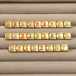 Close-up of golden stainless steel modular charms with colorful alphabet letters for DIY bracelets