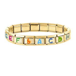 Close-up of gold stainless steel modular charm links with colorful letter patterns
