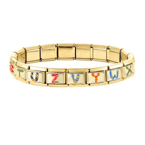 Detail of gold Italian charm bracelet links featuring colorful artistic alphabet patterns