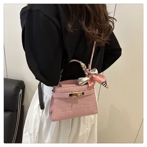 Pink faux leather square bag with crocodile pattern, metal lock and silk scarf detail