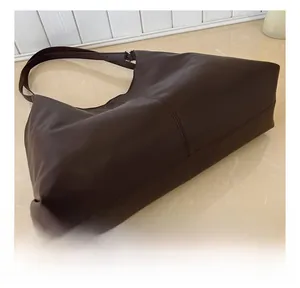 Detailed view of the reinforced double stitching on this large dark brown tote bag