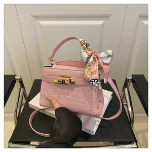 Pink faux croc leather mini bag with gold lock and floral silk scarf detail