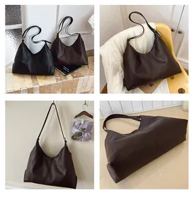 Close-up detail of vintage large leather tote bag with central stitching and soft texture