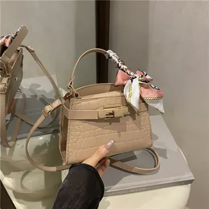 Chic beige crocodile texture square crossbody bag with gold lock and silk scarf detail