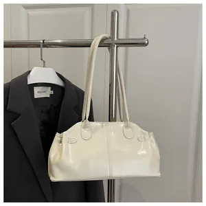 Detail of a minimalist off-white glossy faux leather tote bag with double shoulder straps