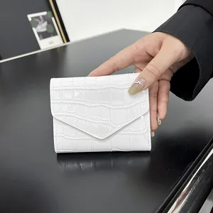 White patent faux leather envelope clutch bag with crocodile texture and magnetic flap