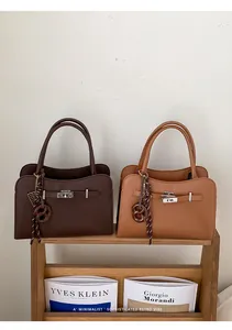 Detailed view of luxury leather tote bags with metal turn-lock and vintage straps