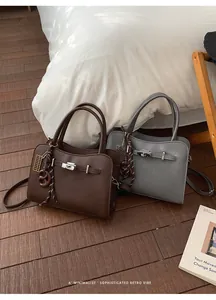 Detailed view of vintage lychee grain leather handbags with metal twist locks and charms