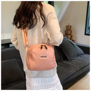 Pink PU leather travel makeup bag with adjustable strap and dual zipper detail