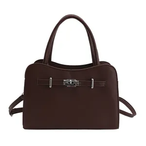 Elegant vintage dark brown leather handbag with wavy top and silver clasp on white background