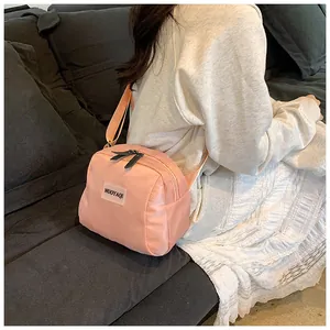 Pink portable travel makeup pouch shown being worn as a crossbody shoulder bag