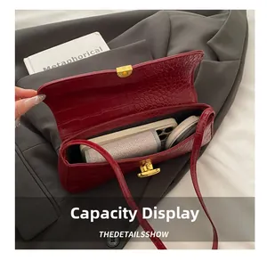 Macro view of burgundy crocodile pattern shoulder bag showing spacious interior capacity