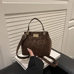 Leopard print crossbody bag with gold lock and top handle in vintage brown suede style