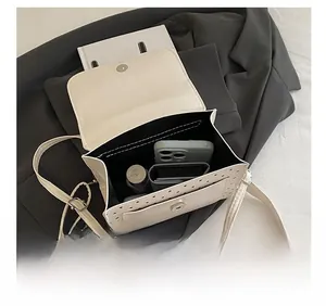 Internal capacity of cream-white PU leather backpack with polka dot hollow pockets