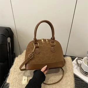 Brown shell-shaped crossbody bag in mixed leather and leopard texture on knit fabric