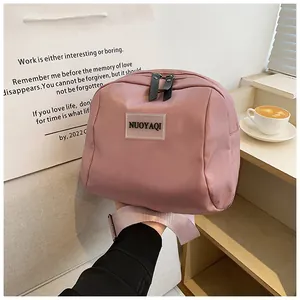Close-up of pink PU leather makeup bag featuring durable metal zippers and brand label