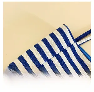 Detail of blue and white striped canvas tote with reinforced stitching and textured fabric