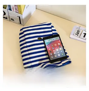 Detail shot showing the large capacity of the blue striped canvas tote bag with a tablet