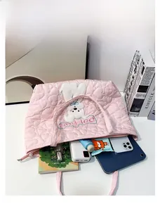 Internal view of pink quilted tote bag showing large capacity with tablet and phone