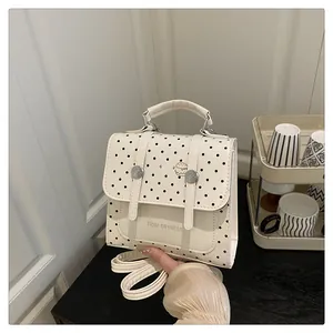 Detail of polka dot mini bag with hamburger patch and adjustable shoulder straps