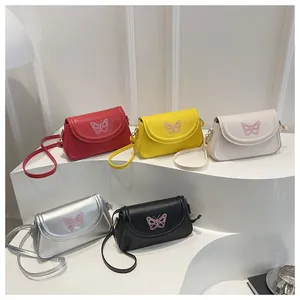 Detailed display of five colorful butterfly flap handbags in red, yellow, cream, silver and black