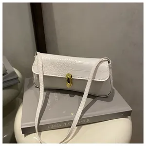 Close-up of white crocodile texture faux leather with a golden metallic lock detail