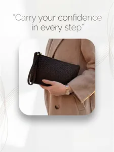 Detail of hand-woven dark brown leather clutch bag with metal zipper and wristlet strap