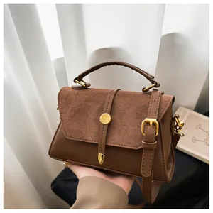 Detailaufnahme der braunen Retro-Handtasche mit hochwertigem Wildleder und PU-Ledertextur