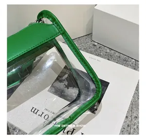 Close-up of green leather stitching and transparent PVC material with silver metal ring