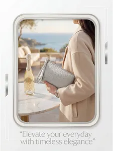 Silver woven texture clutch bag with wrist strap shown in an elegant seaside setting