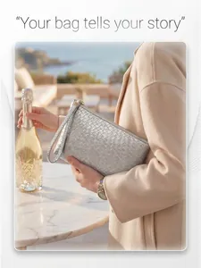Detailed view of silver woven leather clutch with gold zipper and wristlet strap