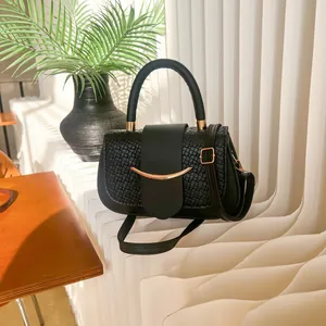 Elegant black crocodile embossed handbag with gold metallic accent and stylish top handle