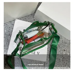 Internal capacity of green transparent PVC crossbody bag showing lipstick storage