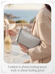 Silver woven clutch bag featuring metallic texture and gold zipper in a luxury seaside setting
