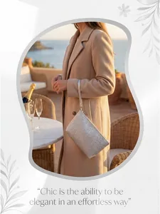 Detail of silver woven leather clutch with a wristlet strap in a luxury sunset setting