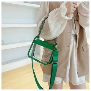 Green transparent square bag with chain handle and adjustable wide fabric strap