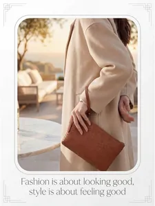Close-up of brown woven leather clutch bag with wristlet strap and zipper detail